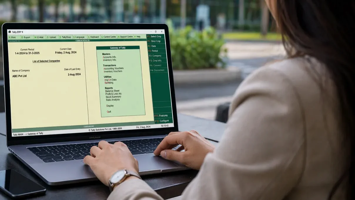 A woman working in Tally on a laptop at an outdoor table